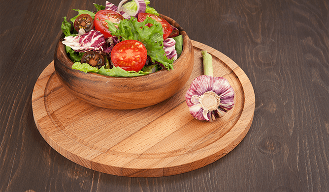 To get subtle garlic flavor in the salad, rub a cut garlic pod